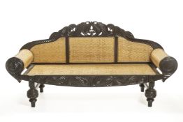 AN ANGLO INDIAN CARVED TEAK SOFA