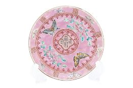 A PINK GROUND FAMILLE ROSE 'BUTTERFLY' SAUCER