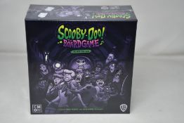 A boxed and sealed as new Scooby-Doo The Board Game Deluxe Edition (REF: 889696013064).