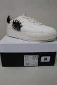 A pair of women's boxed as new Kurt Geiger London Laney Eye Sneakers in white (EU 41).