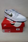 An as new pair of Nike Dunk Low in White/Blackened Blue-Volt (Size UK 14).