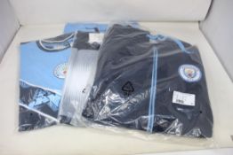 Three Official Merchandise Manchester City logo tee shirts and one full zip hoodie (Size 4 x M).