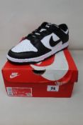 An as new pair of Nike Dunk Low Retro in White/Black-White (Size UK 9) (Box has some damage).
