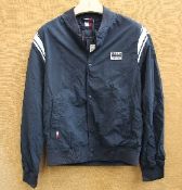 An as new Tommy Hilfiger Varsity Bomber Jacket - Desert Sky (S).