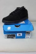 A pair of as new Nike x Undefeated 5 On It Dunk Low SP in Black/Black (Size UK 8) (Box Damaged).