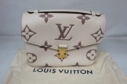 An as new Louis Vuitton Pochette Metis Cross-Body Leather Bag in Creme/Bois De Rose.