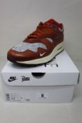 A pair of boxed as new Nike Air Max 1 Patta 'Waves' in Dark Russet (UK 11).