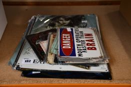 A quantity of unbranded metal posters with various designs.