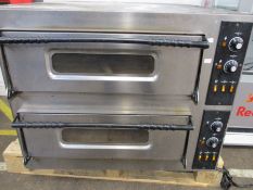 A large pre-owned commercial double deck pizza oven.