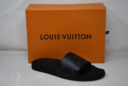 A pair of boxed Louis Vuitton Waterfront Mule slides in black and dust covers (Size 8 1/2).