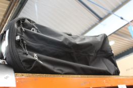 An Ogio Equipment Rig wheel gear bag in Black (Has some minor damage).