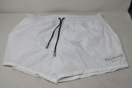 A pair of white Balmain swimming boxer short and black drawstrings (Size XL).