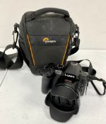 A pre-owned Panasonic Lumix FZ330 Rugged Bridge Camera (M/N: DMC-FZ330) with Panasonic Battery and L