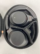 A pre-owned pair of Sony WH-1000XM3 Noise Cancelling Wireless Headphones with case.