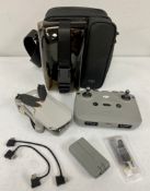 A pre-owned DJI Mavic Mini 2 Drone with two batteries, controller and carry bag.