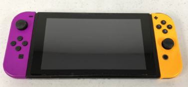 A pre-owned Nintendo Switch Handheld Console with Purple/Orange Joy-Con Controllers (No power supply
