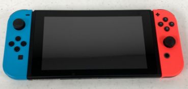 A pre-owned Nintendo Switch Handheld Console with Blue/Red Joy-Con Controllers (No power supply, gam