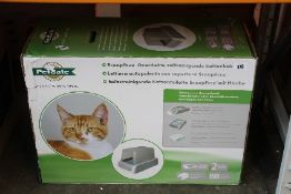 A boxed as new Petsafe Scoopfree covered self clean litter box.