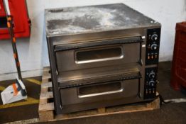 A large pre-owned commercial double deck pizza oven.