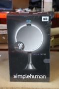 A boxed and sealed as new Simplehuman mirror (Box has some damage).