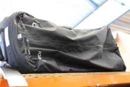 An Ogio Equipment rig wheel gear bag in black (Has some minor damage).