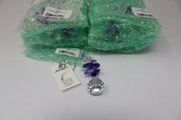 Twelve as new Woodstock Chimes Crystal Sunrise Cascade Sun-Catchers in Purple (EAN: 028375270118).