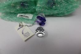 Twelve as new Woodstock Chimes Crystal Sunrise Cascade Sun-Catchers in Purple (EAN: 028375270118).