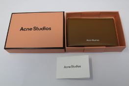 A boxed as new Acne Studios Folded Leather Card Holder in Camel Brown.