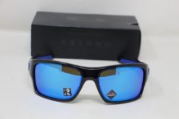 A boxed as new pair of Oakley Turbine Sunglasses in Black Ink with Prizm Sapphire Lens (REF: OO9263,