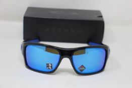 A boxed as new pair of Oakley Turbine Sunglasses in Black Ink with Prizm Sapphire Lens (REF: OO9263,
