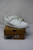A pair of women's Nike Dunk Low Next Nature in pale green and white (UK 7.5, boxed but no filling