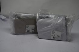 A Carvela Bee Mini X-Body black/comb fabric handbag and a Carvela Micro Bailey pink fabric handbag.