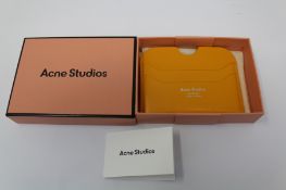 A boxed as new Acne Studios Leather Card Holder in Pumpkin Orange.