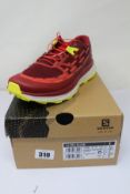 A pair of men's boxed as new Salomon Ultra Glide Trail Running Shoes in Biking Red/Lunar Rock/