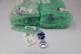 Twelve as new Woodstock Chimes Crystal Sunrise Cascade Sun-Catchers in Purple (EAN: 028375270118).