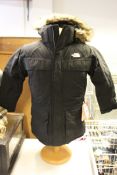 An as new The North Face Mcmurdo down parka (Boys Medium).