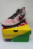 A boxed as new pair of Nike SB Dunk High Pro QS KCDC in Elemental Pink/Black (Size UK 14).