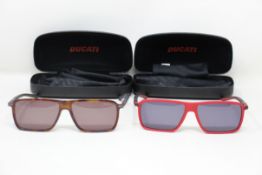 Two pairs of Ducati sunglasses (DA024) (227 59 14-140) and (441 59 14-140).