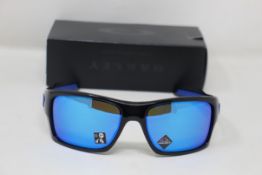 A boxed as new pair of Oakley Turbine Sunglasses in Black Ink with Prizm Sapphire Lens (REF: OO9263,