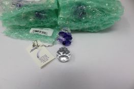 Twelve as new Woodstock Chimes Crystal Sunrise Cascade Sun-Catchers in Purple (EAN: 028375270118).