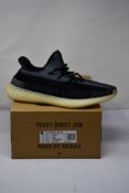A boxed as new Adidas Yeezy Boost 350 V2 Trainers in Carbon/Carbon/Carbon (Size UK 12.5).