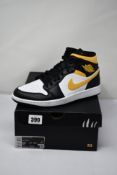 A pair of as new Nike Air Jordan 1 Mid White/Pollen-Black (Size UK 8.5).