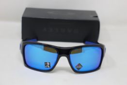 A boxed as new pair of Oakley Turbine Sunglasses in Black Ink with Prizm Sapphire Lens (REF: OO9263,