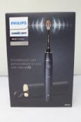 A boxed as new Phillips Sonicare 9900 power toothbrush with sense IQ.