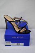 A pair of Stuart Weitzman Ellsie 100 black patent heeled sandals (Size EU 40.5).