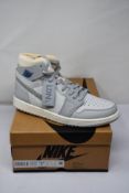A pair of boxed as new Nike Air Jordan 1 High Zoom Air CMFT London in Photon Dust/Light Smoke