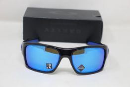 A boxed as new pair of Oakley Turbine Sunglasses in Black Ink with Prizm Sapphire Lens (REF: OO9263,