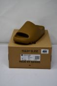 A pair of as new Yeezy Slide in Ochre (Size UK 7).