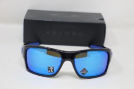 A boxed as new pair of Oakley Turbine Sunglasses in Black Ink with Prizm Sapphire Lens (REF: OO9263,