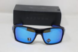 A boxed as new pair of Oakley Turbine Sunglasses in Black Ink with Prizm Sapphire Lens (REF: OO9263,